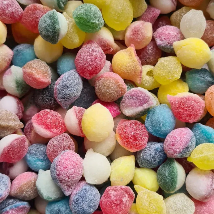 A variety of colorful sugar-coated candies, also known as pips, displayed in a dense collection.