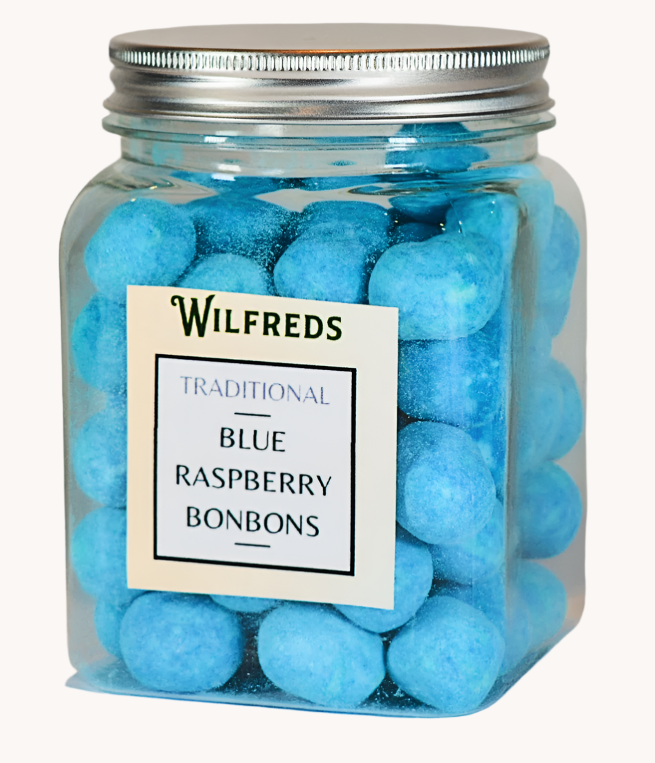 A clear jar filled with blue raspberry bonbons, with a label on the front that reads 'Wilfreds Traditional Blue Raspberry Bonbons'.
