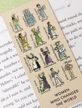 Book with a bookmark titled 'Women Who Changed the World' on a green background
