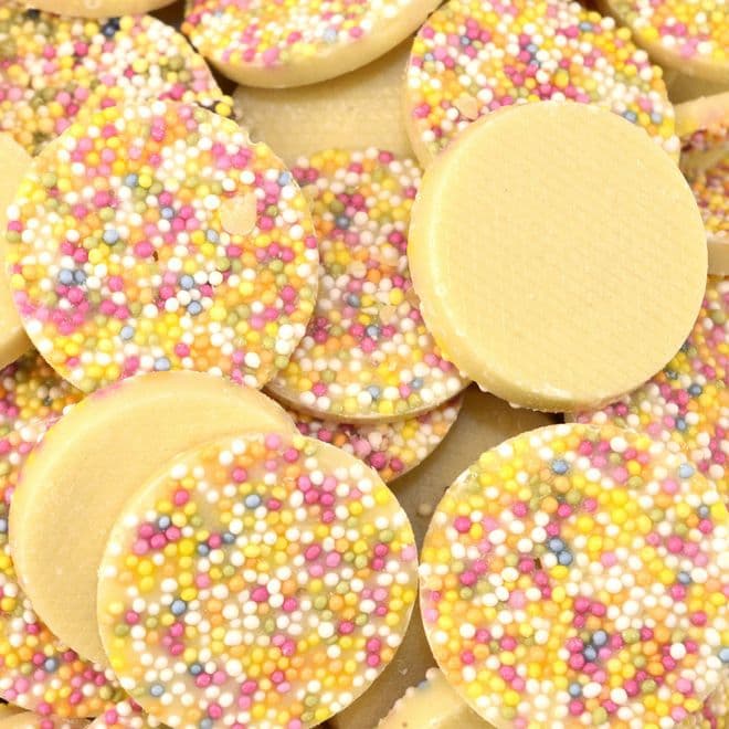 A collection of chocolate snowies covered in multicolored candy sprinkles.